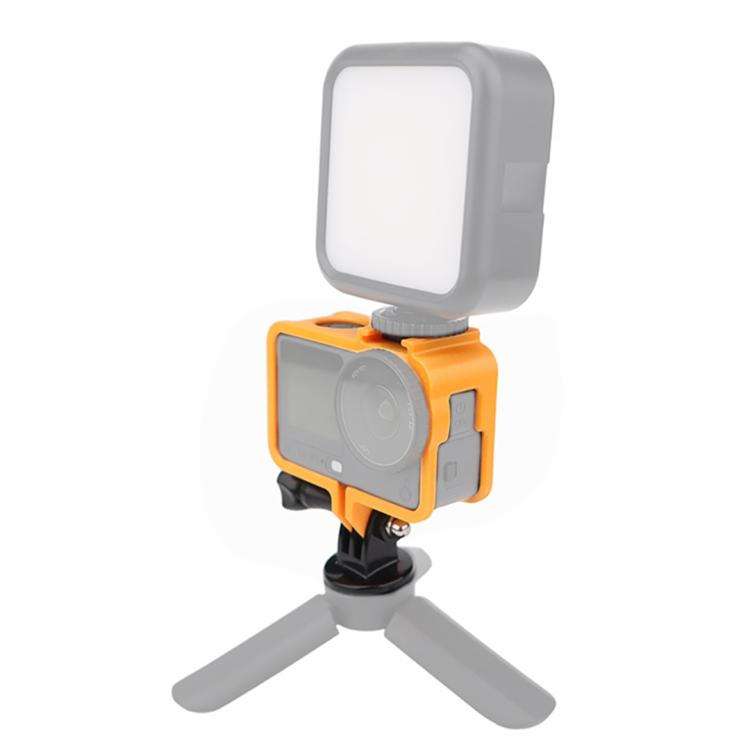 Cold Shoe Cage Expansion Adapter Frame i orange med monterad LED-lampa, visar tillbehörsmontering via cold shoe-fäste.