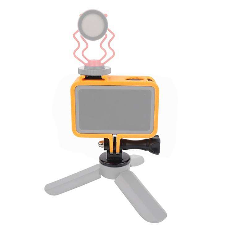 Baksida av orange Cold Shoe Cage Expansion Adapter Frame med monterad mikrofon, demonstrerar tillbehörsexpansion.